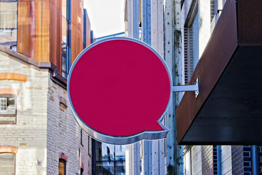 Empty round blank signboard mockup hung on business facade